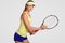 Healthy lifestyle concept. Motivated active experienced lovely female tennis player, ready to make short ball, holds tennis racque