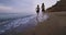 Healthy lifestyle concept two young ladies running in the morning on the beach through the water with amazing landscape