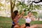 Healthy and lifestyle concept,Young woman raise up hands and relax at public park in the morning together,Happy and smiling,Positi