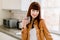 Healthy lifestyle, everyday morning routine. Young dark haired woman in yellow casual shirt, holding glass with mineral