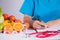 Healthy lifestyle, food and nutrition concept. Close up of fresh vegetables and fruits with stethoscope lying on doctor`s desk