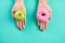 Healthy lifestyle, food and sport concept. Top view of healthy versus unhealthy. Woman hand holding donut and green apple on blue