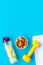 Healthy lifestyle, healthy habits. Detox water, fruit salad, sport equipment dumbbells on blue background top view copy