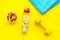Healthy lifestyle, healthy habits. Detox water, fruit salad, sport equipment dumbbells on yellow background top view