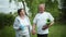 Healthy lifestyle, older men and women couples take hold on hands after morning workout outdoors near river among trees