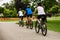 Healthy lifestyle - people riding bicycles in city park