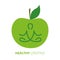 Healthy lifestyle person in yoga pose and green apple