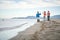 Healthy Lifestyle By The Sea. People on beach doing some fitness workout