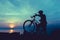 Healthy lifestyle. Silhouette of bicyclist standing with bike at