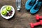 Healthy lifestyle sport equipment fitness, sneakers, green apple, fresh water and healthy food on old wood background.