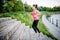 Healthy lifestyle sports woman running on street stairs along ri