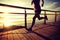 Healthy lifestyle woman runner running seaside