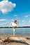 Healthy lifestyle young woman practice yoga on  dried trunk on the river beach fresh air sunny summer day