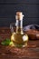 Healthy Linseed oil in glass bottle. Dark wooden background Copy space