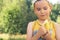 Healthy little boy eating banana. Happy kid enjoy eating fresh fruit.