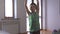 healthy little boy lifting dumbbells indoors at bright home room during sport fitness workout training