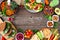 Healthy lunch food frame with nutritious Buddha bowl, lettuce wraps, sandwiches, salad and vegetables, overhead view over a rustic