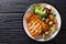 Healthy lunch grilled swordfish fillet with fried potatoes and fresh salad close-up on a plate. Horizontal top view