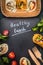 Healthy lunch Lettering with vegetarian wraps and wooden cutlery on dark chalkboard, top view