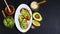 Healthy lunch snack, three delicious avocado sandwiches, fresh sliced avocados, honey, sesame seeds on an earthenware plate, copy