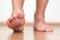 Healthy male feet stepping over home-like