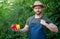 healthy man greengrocer in straw hat with bell pepper