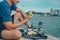 Healthy man hold apple fruit and sitting on the stone near the beach