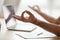 Healthy man meditating at home office desk doing yoga, closeup