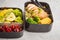 Healthy meal prep containers with grilled chicken with fruits, b