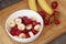 Healthy meal with strawberry and bananas. Organic natural diet concept, real natural fruits, fresh and washed, in white bowl on w