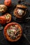 Healthy meat free food. Orange pumpkins stuffed with brown and white rice, giant couscous, mushrooms, onion and grated cheese on