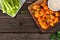 Healthy meatless cauliflower buffalo wings, top view table scene against wood with copy space