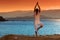 Healthy middle aged woman doing fitness stretching outdoors