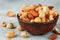 Healthy mix of different nuts in a bowl on a gray concrete or stone background. Almonds, hazelnuts, cashews. A Useful snack. Good