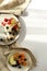 Healthy morning  breakfast with morning light of granola, fruits, berries, yogurt  on white background on white round plate