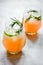 Healthy morning with fresh drink, lime and rosemary on stone table background