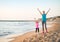 Healthy mother and baby girl rejoicing on beach