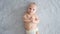 A healthy newborn baby in a nappy without clothes. Cute baby with blue eyes . Happy newborn boy lies on a blue blanket and