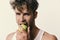 Healthy nutrition concept. Athlete with messy hair eats fresh fruit. Man with apple