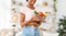 Healthy nutrition for weight loss. Black lady with tape measure holding bowl of fruits and vegetables at home, closeup