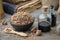 Healthy oak bark in ceramic bowl, infusion bottle and old books on table. Herbal medicine