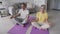 Healthy old couple meditating at home learning yoga online classes tutorials.