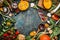 Healthy and organic harvest vegetables and ingredients: pumpkin, greens, tomatoes,kale,leek,chard,celery on rustic kitchen table b