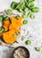 Healthy organic raw ingredients for making vegetarian lunch - butternut squash, spinach, wild rice on white background, top view.