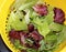 Healthy organic Spring Mix lettuce leaves after rinsing in colander