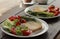 Healthy organic vegetable breakfast, tomato toast salad basil cucumber arugula