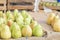 Healthy Organic yellow Pears on the table with burlap at village fair. Fruit harvest fresh picked William Bartlett pears in the