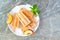 Healthy peach yogurt popsicles on a plate, top view over dark stone