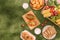 Healthy picnic for a summer vacation with freshly baked croissants, fresh fruit and fruit salad, sandwiches and a glass of