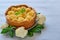 Healthy pie with cauliflower on the gray plate decorated with fresh basil leaves. Vegetarian cauliflower tart on the gray table